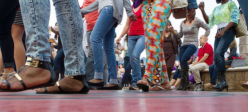 Military spouses enjoy som line dancing.