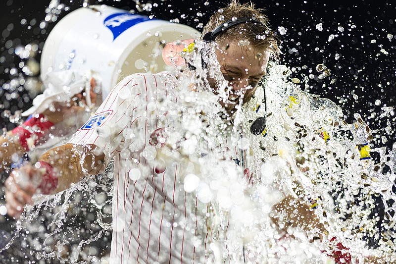 Sep 9, 2024; Philadelphia, Pennsylvania, USA; Philadelphia Phillies first base Kody Clemens (2) has a cooler of water and seeds dumped on him after his game winning walk off RBI single during the ninth inning against the Tampa Bay Rays at Citizens Bank Park. Mandatory Credit: Bill Streicher-Imagn Images