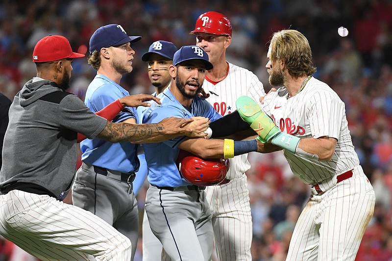 Sep 10, 2024; Philadelphia, Pennsylvania, USA; Philadelphia Phillies first base Bryce Harper (3) is held back by Tampa Bay Rays shortstop JosŽ Caballero (7) and  shortstop Taylor Walls (6)  during scuffle in the eighth inning at Citizens Bank Park. Mandatory Credit: Eric Hartline-Imagn Images