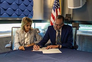 USDA RD State Director Jane Asselta and ACIA Executive Director Tim Edmunds sign paperwork for the Intermediary Relending Program Award Sep. 10 in Egg Harbor Township.