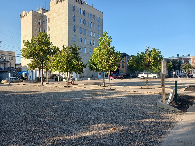 The two parking lots being acquired by the city are behind the former Crown Bank building, seen in the background.