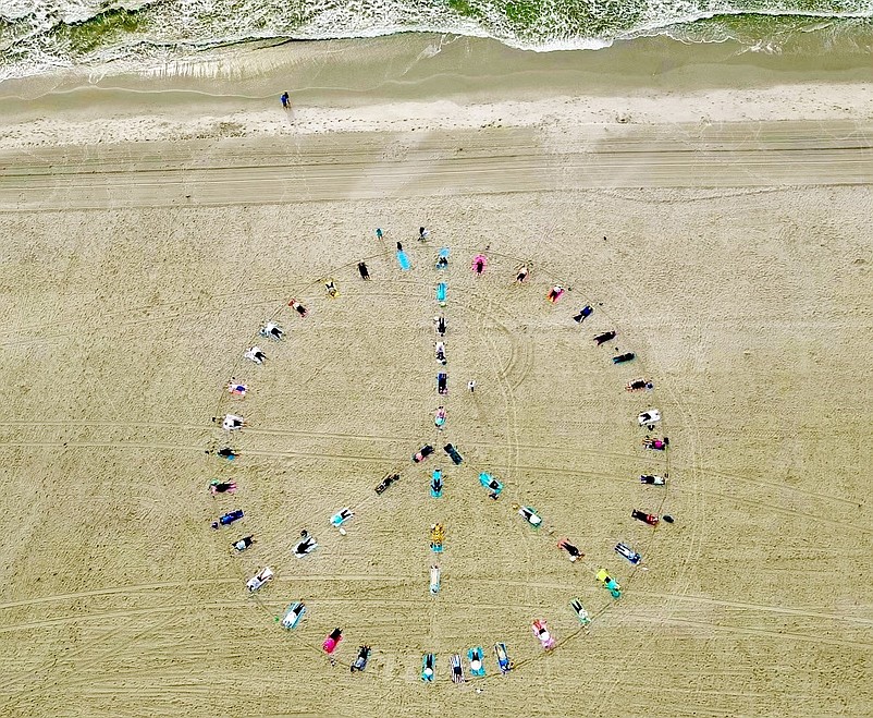 The yoga class forms a peace sign on the Sea Isle City beach at JFK Boulevard. (Photo courtesy of Sea Isle City)