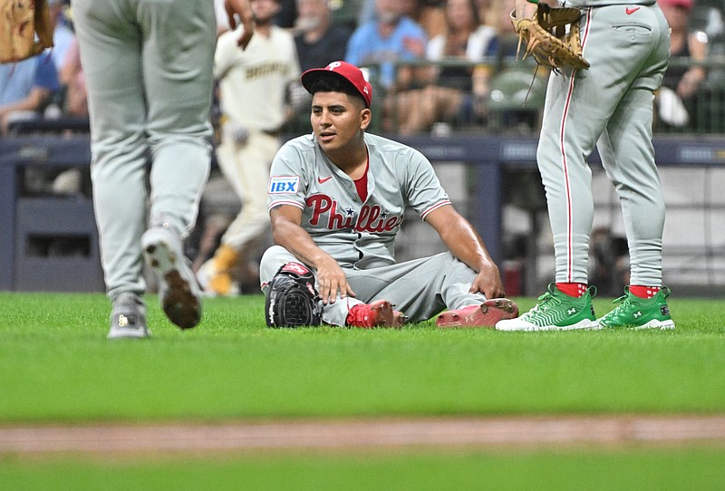 Sep 16, 2024; Milwaukee, Wisconsin, USA; Philadelphia Phillies pitcher Ranger Su‡rez (55) goes down after trying to field a bunt against the Milwaukee Brewers in the fourth inning at American Family Field. Mandatory Credit: Michael McLoone-Imagn Images