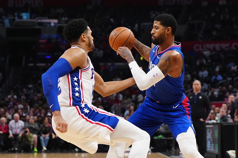 Jan 17, 2023; Los Angeles, California, USA; LA Clippers guard Paul George (13) is defended by Philadelphia 76ers forward Tobias Harris (12) in the second half at Crypto.com Arena. Mandatory Credit: Kirby Lee-USA TODAY Sports