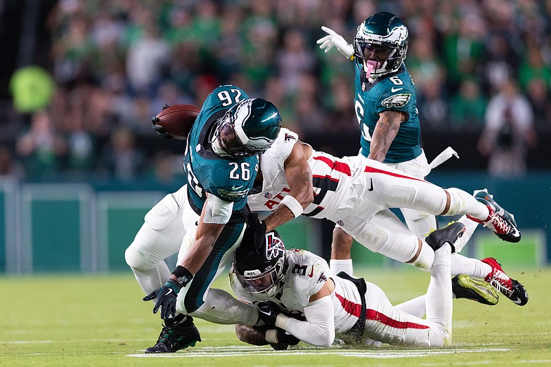 Sep 16, 2024; Philadelphia, Pennsylvania, USA; Philadelphia Eagles running back Saquon Barkley (26) is tackled by Atlanta Falcons safety Jessie Bates III (3) and cornerback A.J. Terrell (24) during the fourth quarter at Lincoln Financial Field. Mandatory Credit: Bill Streicher-Imagn Images