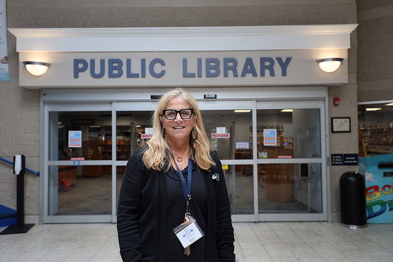 Library Director Karen Mahar welcomes back library patrons.