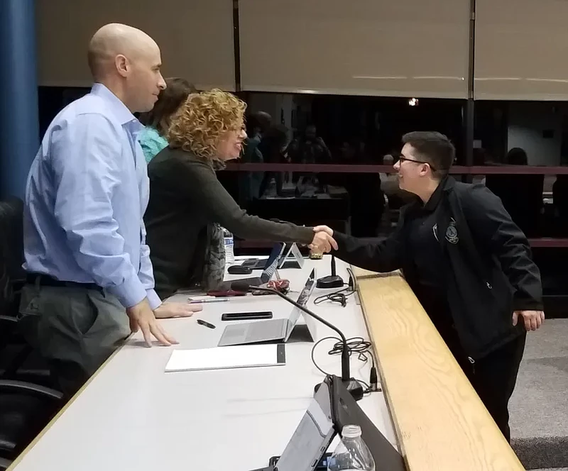 Adrianna Ciliberto, newly promoted to the position of police Communications Specialist Supervisor, shakes hands with Montgomery Township’s Director of Administration and Human Resources Ann Shade, center, and Finance Director Brian Shapiro during the supervisors’ Jan. 27 2020 meeting.