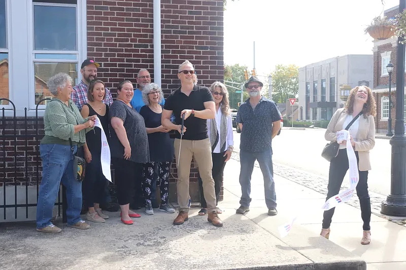 Eye Curious Atelier owner Kenoka Wagner cuts the ribbon at the Souderton art gallery’s grand opening celebration Thursday afternoon.