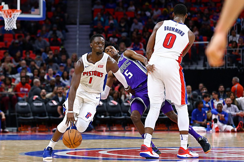 Nov 4, 2017; Detroit, MI, USA; Detroit Pistons center Andre Drummond (0) is called for a foul as he attempts to set a screen against Sacramento Kings guard De'Aaron Fox (5), while Detroit Pistons guard Reggie Jackson (1) controls the ball in the second half at Little Caesars Arena. Mandatory Credit: Aaron Doster-USA TODAY Sports