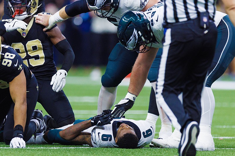 Sep 22, 2024; New Orleans, Louisiana, USA; Philadelphia Eagles wide receiver DeVonta Smith (6) is injured on a tackle by New Orleans Saints defensive tackle Khristian Boyd (97) during the second half at Caesars Superdome. Mandatory Credit: Stephen Lew-Imagn Images