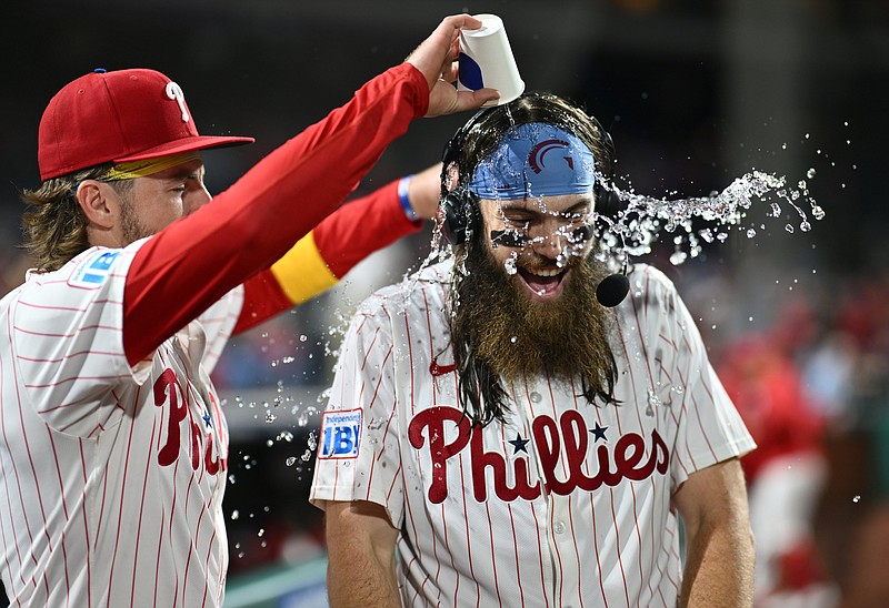 Sep 25, 2024; Philadelphia, Pennsylvania, USA; Philadelphia Phillies outfielder Brandon Marsh (16) is showered by second baseman Bryson Stott (5) after the game against the Chicago Cubs at Citizens Bank Park. Mandatory Credit: Kyle Ross-Imagn Images