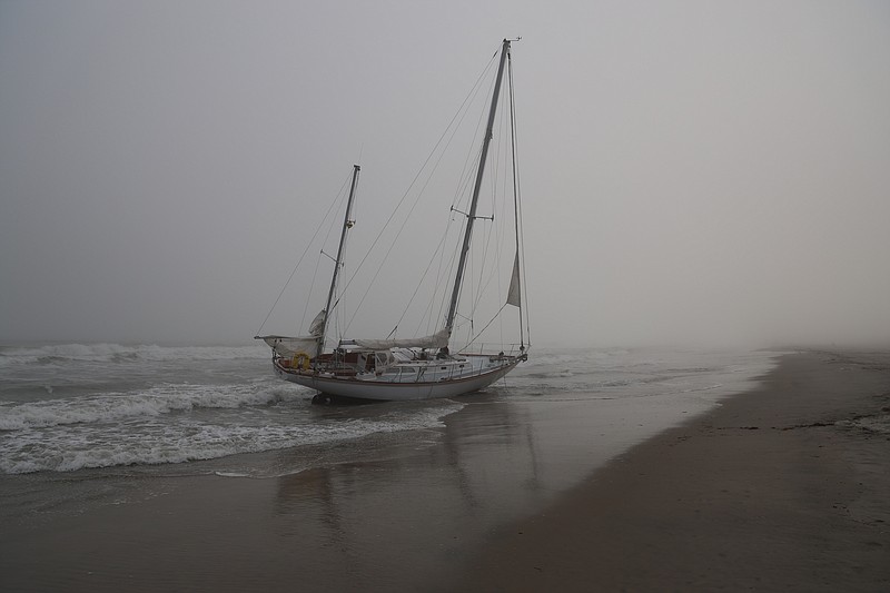 The sailboat runs aground on Sept. 28 near the 22nd Street beach in Ocean City. (Photos and video by Max Kelly)