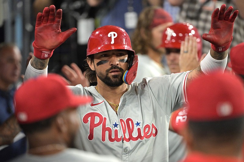 Aug 6, 2024; Los Angeles, California, USA;  Philadelphia Phillies right fielder Nick Castellanos (9) is congratulated in the dugout after scoring a run against the Los Angeles Dodgers at Dodger Stadium. Mandatory Credit: Jayne Kamin-Oncea-USA TODAY Sports