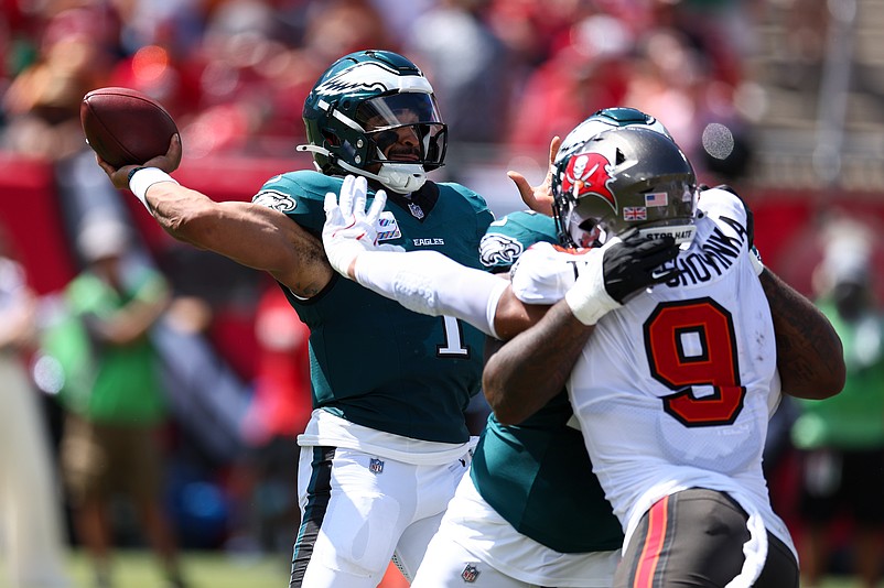 Sep 29, 2024; Tampa, Florida, USA; Philadelphia Eagles quarterback Jalen Hurts (1) is pressured by Tampa Bay Buccaneers linebacker Joe Tryon-Shoyinka (9) in the second quarter at Raymond James Stadium. Mandatory Credit: Nathan Ray Seebeck-Imagn Images