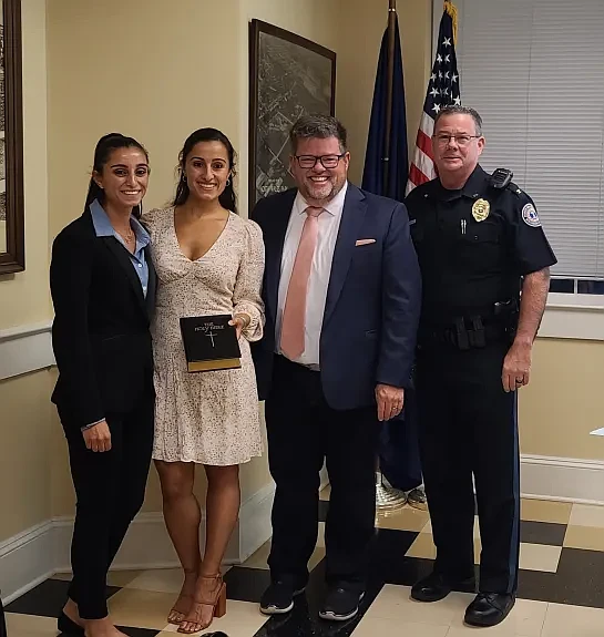 New North Wales Borough police officer Haylie Brass, left, poses with a family member after receiving her oath from borough Mayor Neil McDevitt and police Chief Dave Erenius.