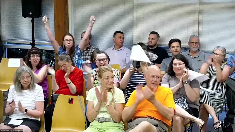 Towamencin residents clap and cheer after the township supervisors announced plans to end the pending sale of the municipal sewer system on Wednesday, Aug. 28, 2024. (Screenshot of meeting video)