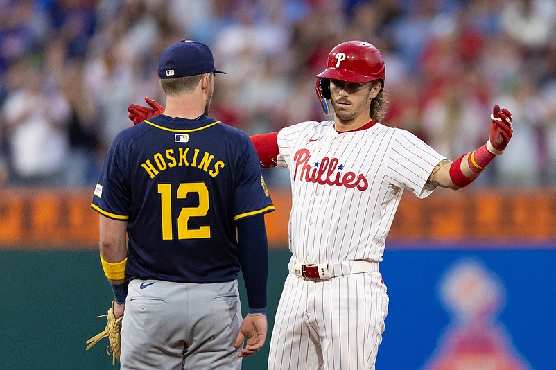 Jun 4, 2024; Philadelphia, Pennsylvania, USA; Philadelphia Phillies second base Bryson Stott (5) reacts in front of Milwaukee Brewers first base Rhys Hoskins (12) after hitting a double during the sixth inning at Citizens Bank Park. Mandatory Credit: Bill Streicher-USA TODAY Sports