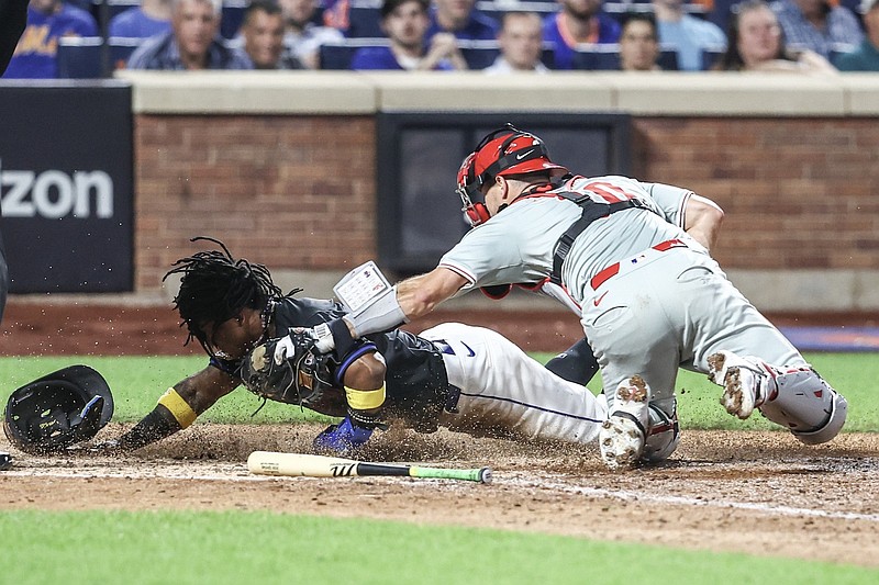 Sep 19, 2024; New York City, New York, USA;  New York Mets shortstop Luisangel AcuÃ±a (2) is tagged out at home plate by Philadelphia Phillies catcher J.T. Realmuto (10) in the seventh inning at Citi Field. Mandatory Credit: Wendell Cruz-Imagn Images