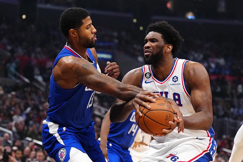 Jan 17, 2023; Los Angeles, California, USA; Philadelphia 76ers center Joel Embiid (21) is fouled by LA Clippers guard Paul George (13) in the first half at Crypto.com Arena. Mandatory Credit: Kirby Lee-USA TODAY Sports