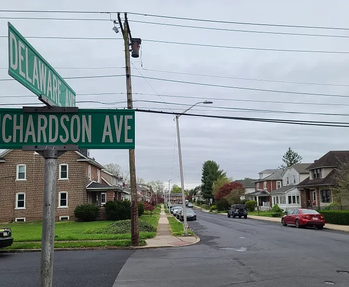 Parked cars and potholes can be seen on the 300 block of Delaware Avenue in Lansdale in April 2024.