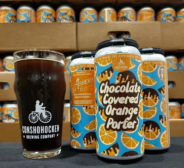 Asher’s Chocolate Co., has partnered with Conshohocken Brewing Co. to launch a limited-edition Chocolate Orange Porter, which went on sale on Friday, Oct. 4. A portion of the proceeds from the collaboration will benefit local pediatric cancer research efforts. (Photo Courtesy Conshohocken Brewing/Asher’s Chocolate)