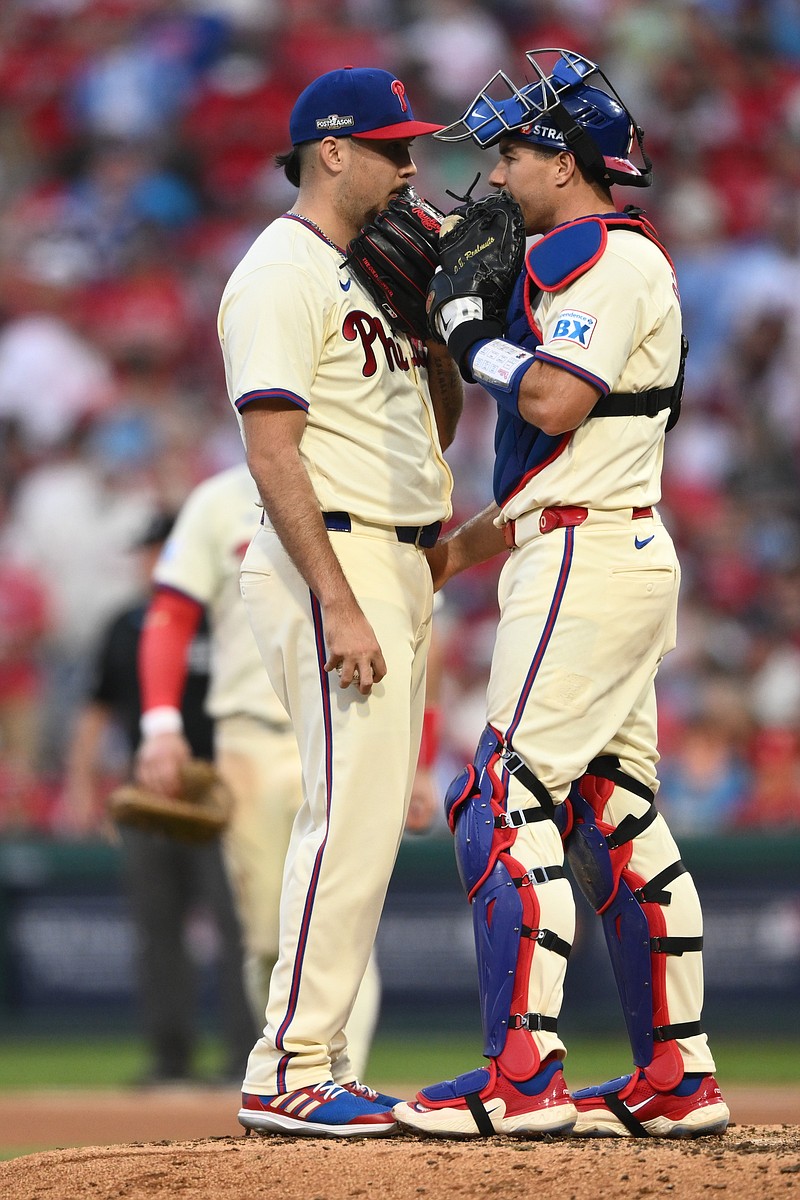 Oct 6, 2024; Philadelphia, Pennsylvania, USA; Philadelphia Phillies pitcher Orion Kerkering (50) and catcher J.T. Realmuto (10) have a meeting at the mound in the seventh inning against the New York Mets during game two of the NLDS for the 2024 MLB Playoffs at Citizens Bank Park. Mandatory Credit: Kyle Ross-Imagn Images