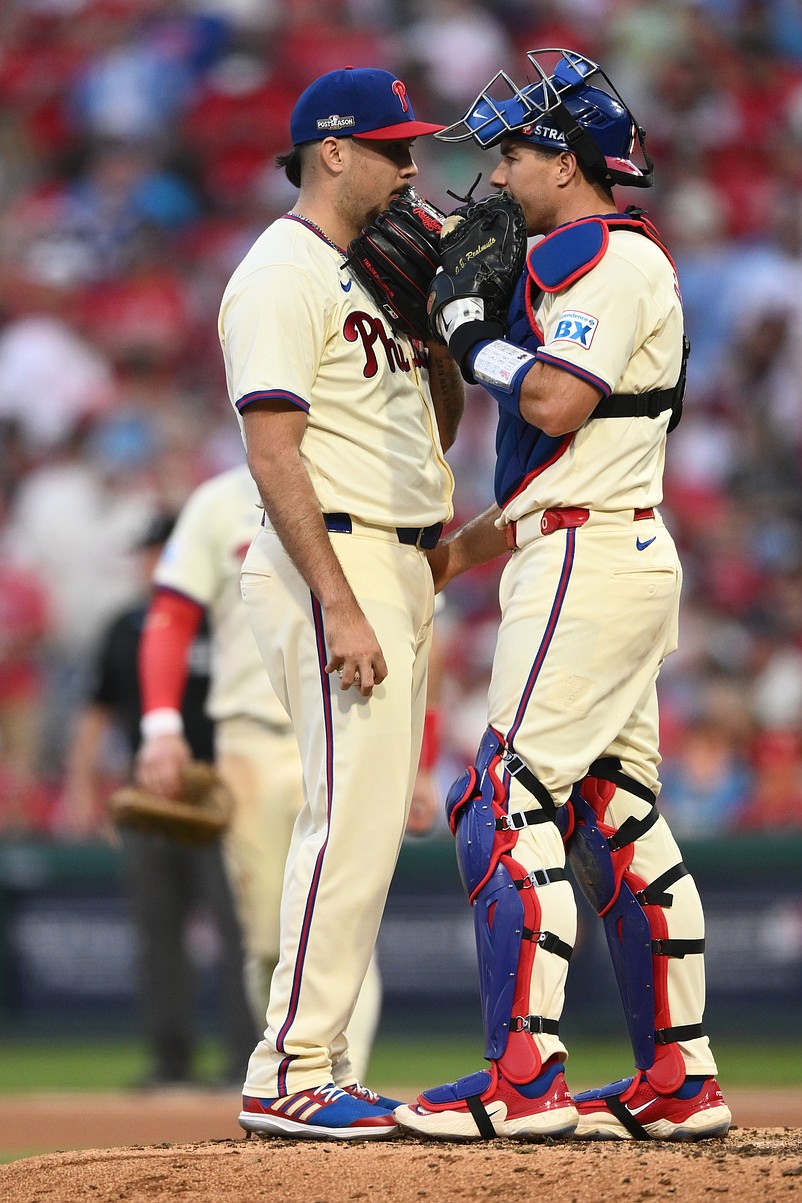 Oct 6, 2024; Philadelphia, Pennsylvania, USA; Philadelphia Phillies pitcher Orion Kerkering (50) and catcher J.T. Realmuto (10) have a meeting at the mound in the seventh inning against the New York Mets during game two of the NLDS for the 2024 MLB Playoffs at Citizens Bank Park. Mandatory Credit: Kyle Ross-Imagn Images