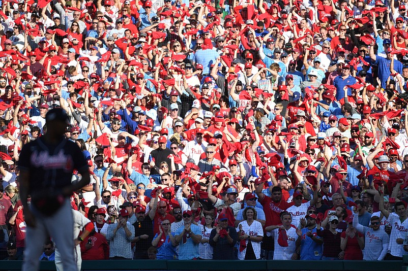 Oct 15, 2022; Philadelphia, Pennsylvania, USA; Philadelphia Phillies fans wave their rally towels as Atlanta Braves relief pitcher Raisel Iglesias (26) prepares to pitch during the sixth inning in game four of the NLDS for the 2022 MLB Playoffs at Citizens Bank Park. Mandatory Credit: Eric Hartline-USA TODAY Sports