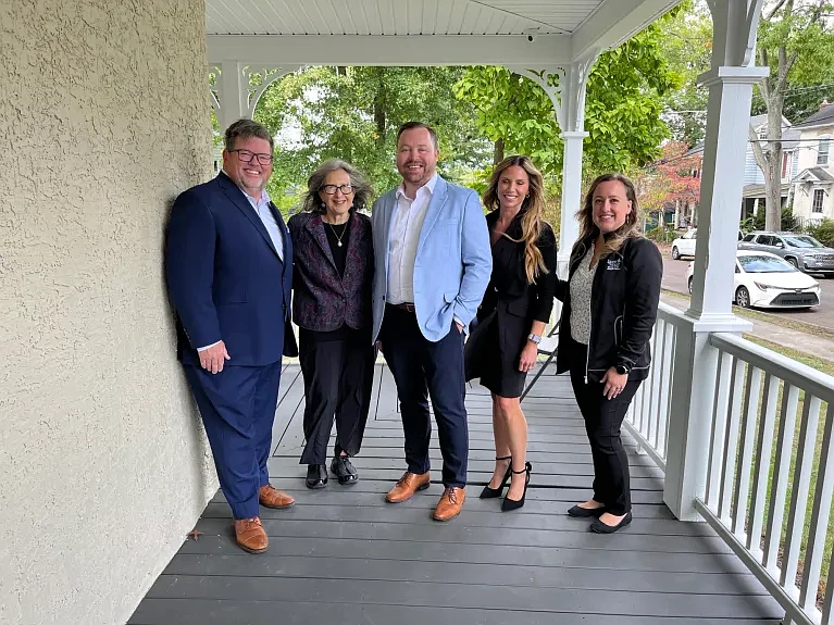 North Wales Mayor Neil McDevitt, Co-Executive Director of Laurel House Beth Sturman, Laurel House Board Co-Presidents Jason Van Buskirk and Melissa Pilong, and Co-Executive Director of Laurel House Stacy Dougherty pose outside a newly refurbished home in North Wales. (Photo courtesy of Laurel House)