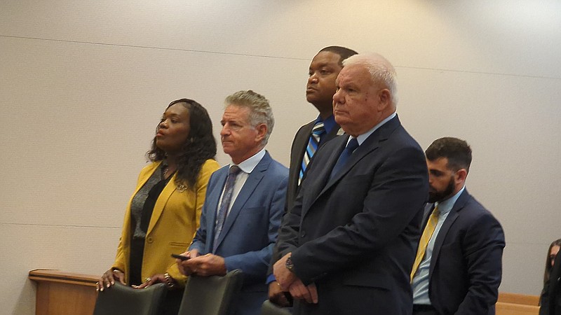 La'Quetta and Marty Small appear with their attorneys Michael Schreiber, second from left,and Ed Jacobs. Behind them is Jordan Barbone, who is working with Jacobs.