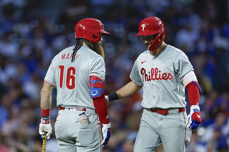 Jul 2, 2024; Chicago, Illinois, USA; Philadelphia Phillies shortstop Trea Turner (7) celebrates with outfielder Brandon Marsh (16) after hitting a two-run home run against the Chicago Cubs during the fifth inning at Wrigley Field. Mandatory Credit: Kamil Krzaczynski-USA TODAY Sports