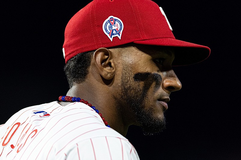 Sep 11, 2024; Philadelphia, Pennsylvania, USA; Philadelphia Phillies outfielder Johan Rojas (18) looks on as he wears a 911 remembrance patch on his cap in a game against the Tampa Bay Rays at Citizens Bank Park. Mandatory Credit: Bill Streicher-Imagn Images