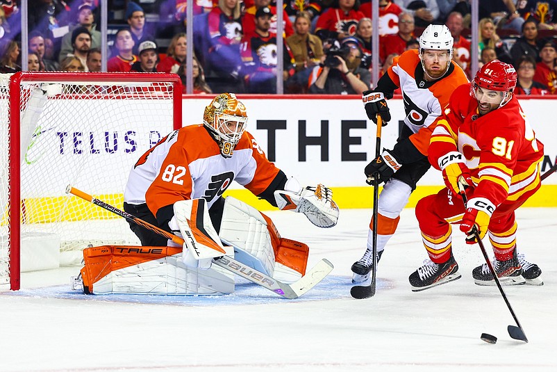 Oct 12, 2024; Calgary, Alberta, CAN; Philadelphia Flyers goaltender Ivan Fedotov (82) guards his net against Calgary Flames center Nazem Kadri (91) during the second period at Scotiabank Saddledome. Mandatory Credit: Sergei Belski-Imagn Images