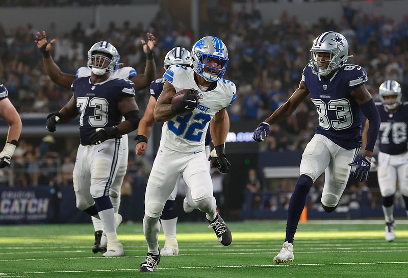 Oct 13, 2024; Arlington, Texas, USA; Detroit Lions safety Brian Branch (32) returns an interception during the second half against the Dallas Cowboys  at AT&T Stadium. Mandatory Credit: Kevin Jairaj-Imagn Images