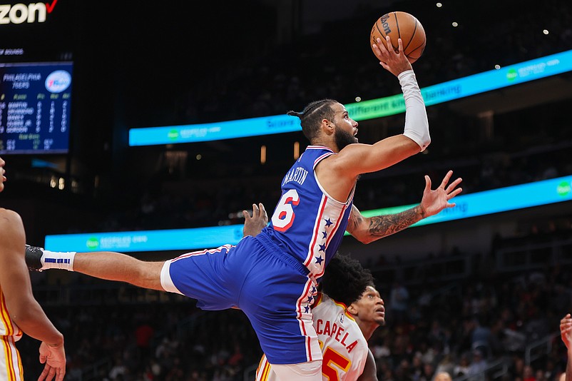 Oct 14, 2024; Atlanta, Georgia, USA; Philadelphia 76ers forward Caleb Martin (16) commits an offensive foul over Atlanta Hawks center Clint Capela (15) in the second quarter at State Farm Arena. Mandatory Credit: Brett Davis-Imagn Images