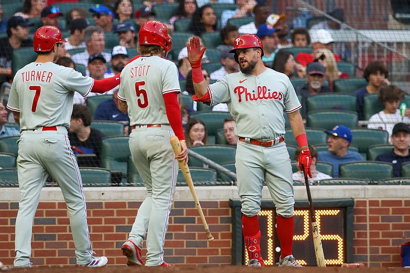 May 26, 2023; Atlanta, Georgia, USA; Philadelphia Phillies shortstop Trea Turner (7) and second baseman Bryson Stott (5) celebrate after scoring with designated hitter Kyle Schwarber (12) against the Atlanta Braves in the third inning at Truist Park. Mandatory Credit: Brett Davis-USA TODAY Sports