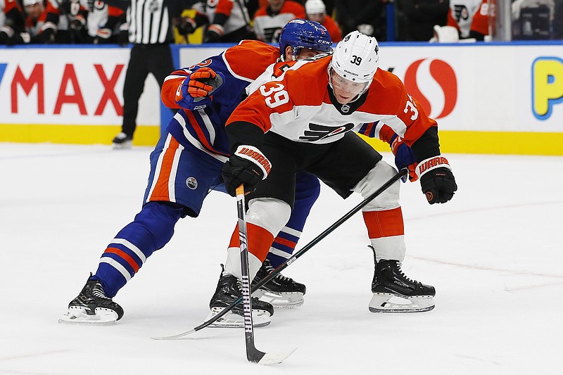 Oct 15, 2024; Edmonton, Alberta, CAN; Edmonton Oilers defensemen Evan Bouchard (2) tries to tie up Philadelphia Flyers forward Matvei Michkov (39) during the second period at Rogers Place. Mandatory Credit: Perry Nelson-Imagn Images