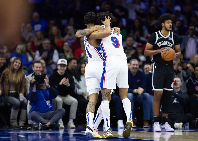 Oct 16, 2024; Philadelphia, Pennsylvania, USA; Philadelphia 76ers forward KJ Martin (1) and guard Kelly Oubre Jr. (9) hug after a score against the Brooklyn Nets during the first quarter at Wells Fargo Center. Mandatory Credit: Bill Streicher-Imagn Images