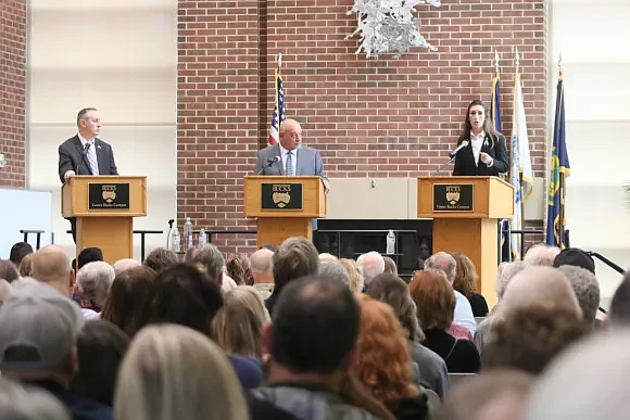 Congressman Brian Fitzpatrick, moderator Bill Pezza, and candidate Ashley Ehasz during the debate. (Credit: Tom Sofield/LevittownNow.com)