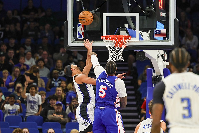 Oct 18, 2024; Orlando, Florida, USA; Orlando Magic guard Jalen Suggs (4) is fouled by Philadelphia 76ers center Andre Drummond (5) during the first quarter at Kia Center. Mandatory Credit: Mike Watters-Imagn Images