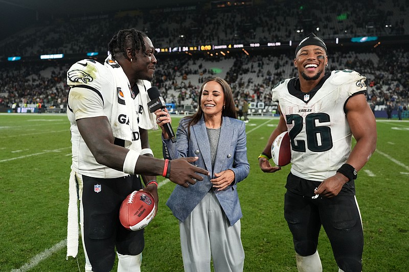 Sep 6, 2024; Sao Paulo, Brazil; Peacock sideline reporter Kaylee Hartung (center) interviews Philadelphia Eagles wide receiver A.J. Brown (11) and running back Saquon Barkley (26) after the 2024 NFL Sao Paolo Game at Neo Quimica Arena. Mandatory Credit: Kirby Lee-Imagn Images