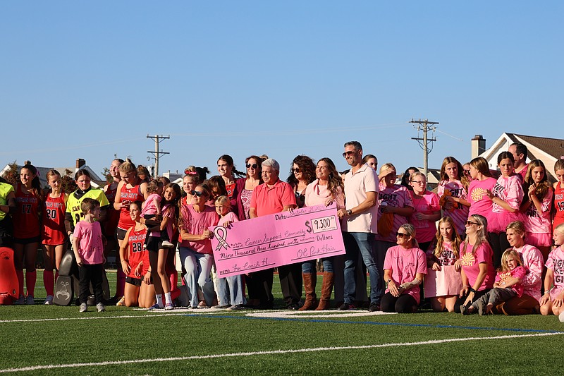 The check presentation ceremony draws a big turnout at Ocean City High School's Carey Stadium.