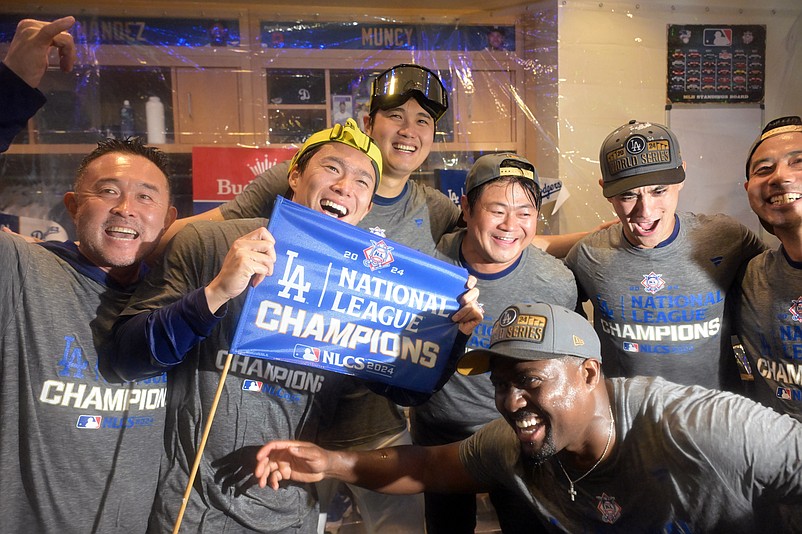 Oct 20, 2024; Los Angeles, California, USA; Los Angeles Dodgers pitcher Yoshinobu Yamamoto (18) and designated hitter Shohei Ohtani (17) celebrate in the clubhouse after defeating the New York Mets in game six of the NLCS for the 2024 MLB playoffs at Dodger Stadium. Mandatory Credit: Jayne Kamin-Oncea-Imagn Images