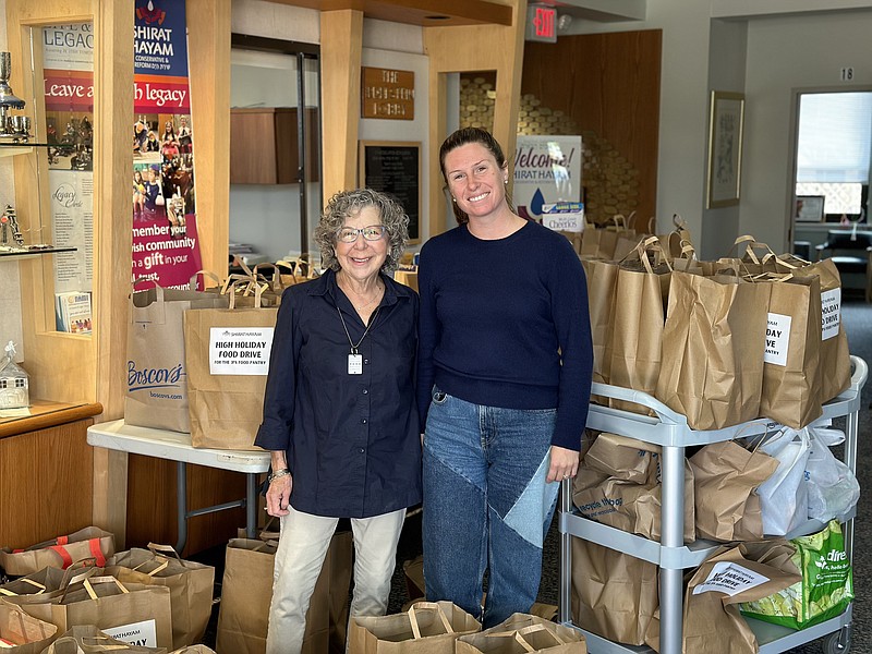 JFS/Julia Tracy, right, of Jewish Family Service of Atlantic & Cape May Counties, picks up High Holidays food donations from Sheila Friedman at Shirat Hayam synagogue.