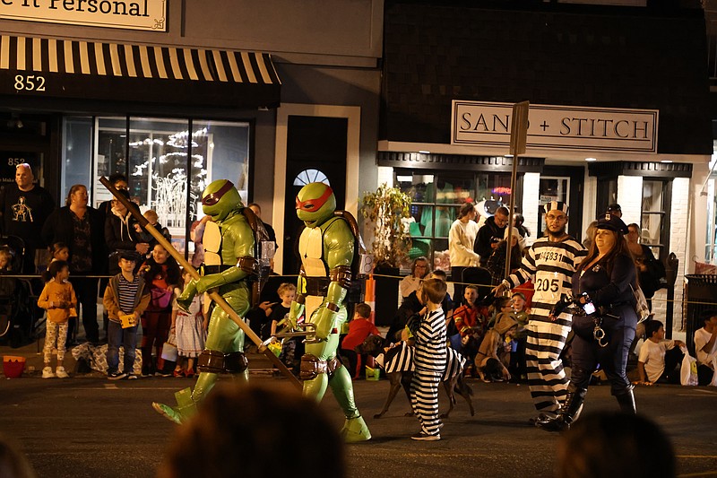 Costumed characters march together to entertain the spectators.