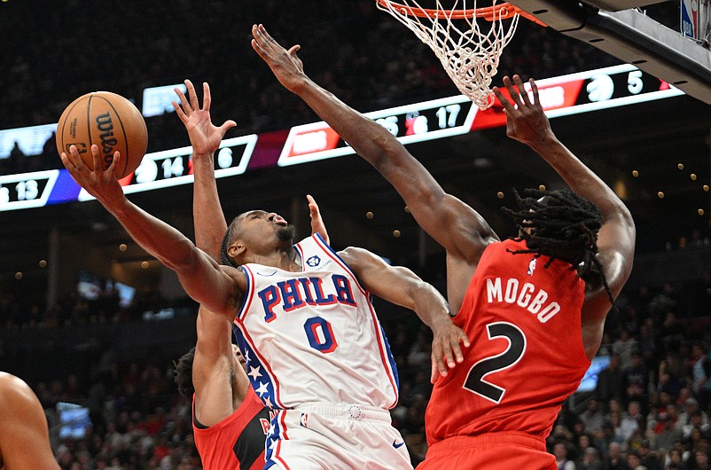 Oct 25, 2024; Toronto, Ontario, CAN;  Philadelphia 76ers guard Tyrese Maxey (0) shoots the ball as Toronto Raptors forward Jonathan Mogbo (2) defends in the first half at Scotiabank Arena. Mandatory Credit: Dan Hamilton-Imagn Images