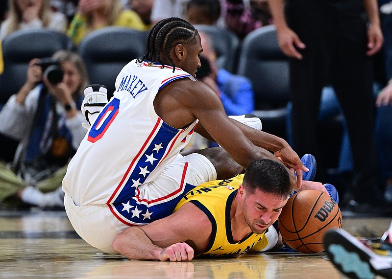 Oct 27, 2024; Indianapolis, Indiana, USA; Indiana Pacers guard T.J. McConnell (9) and Philadelphia 76ers guard Tyrese Maxey (0) dive for the ball during the second quarter at Gainbridge Fieldhouse. Mandatory Credit: Marc Lebryk-Imagn Images