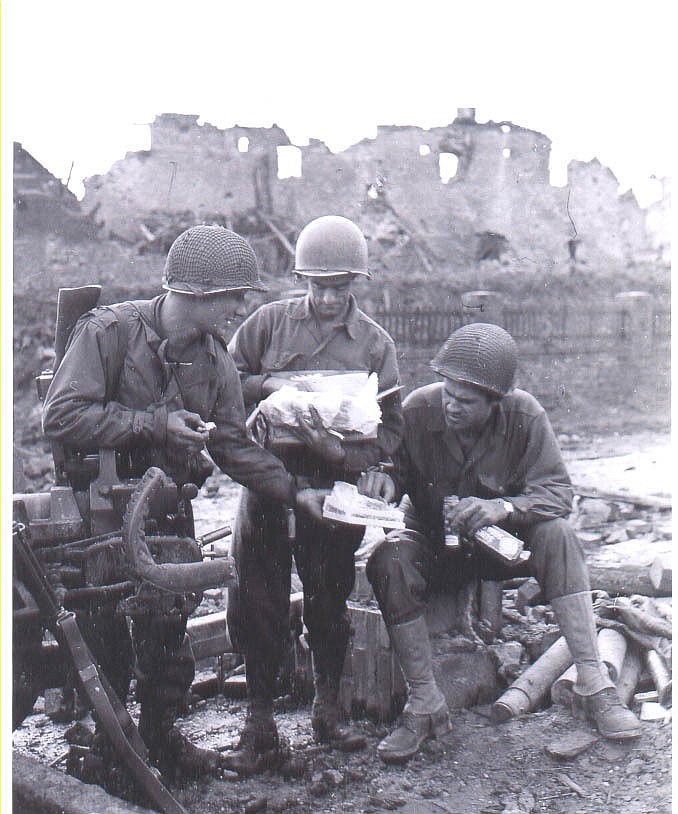 Soldiers with 120th Infantry Regiment, 30th Infantry Division enjoy Christmas care packages sent from home, December 1944...The 30th Infantry Division (nicknamed Old Hickory in WWI) landed at Omaha Beach on Jun. 10, 1944, and entered combat five days later. The division took part in every major campaign in the Europe's western front: Normandy, Northern France, Rhineland, Ardennes – Alsace and Central Europe. (Photo courtesy of 30th Infantry Division Association)