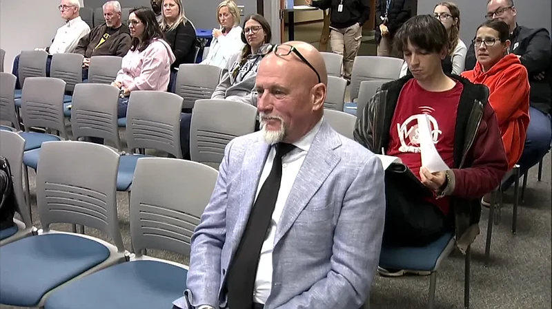 Parents and audience members watch as North Penn school board members introduce new district Director of Facilities and Operations Bill Slawter, front row, during the school board meeting on Thursday, Oct. 17, 2024. (Screenshot of NPTV video)