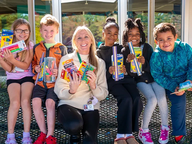 Grasse Elementary School students and principal Casi Plourde display their school supplies. (Courtesy of David Thomas)